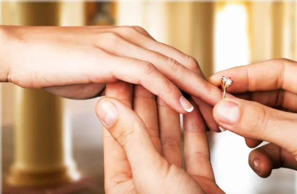 Imagen de una pareja feliz intercambiando votos en un escenario idílico, ilustrando el momento especial de una boda de ensueño.